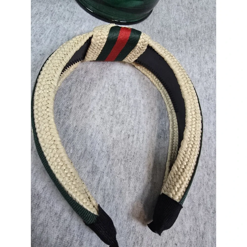 Bee Headband woven straw top-knot headband featuring a red and green striped...